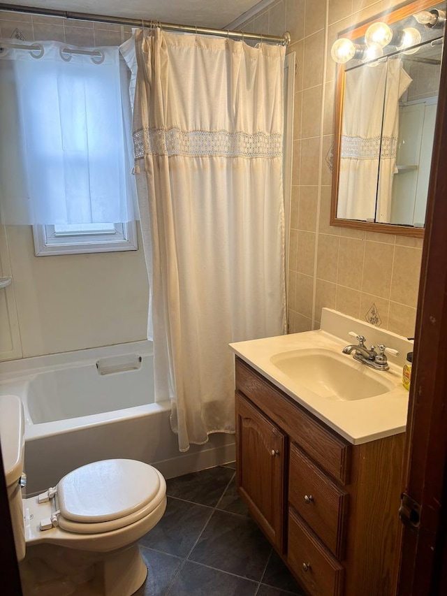 full bath with vanity, shower / bath combo, tile patterned flooring, toilet, and tile walls