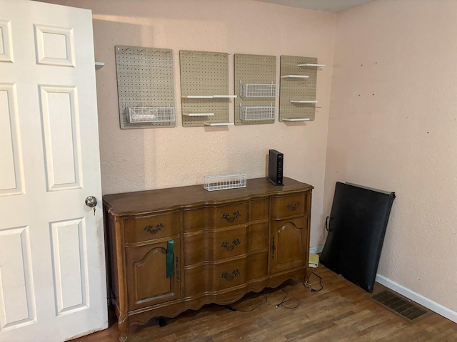 details featuring visible vents, baseboards, and wood finished floors