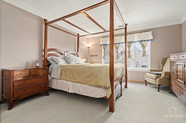 bedroom with baseboards and light colored carpet
