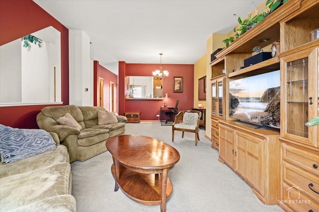 living area featuring light carpet and an inviting chandelier