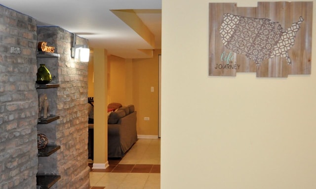 hall featuring tile patterned flooring and baseboards