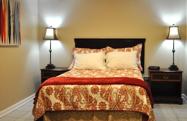 tiled bedroom featuring baseboards