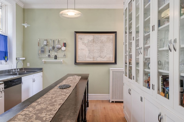 kitchen featuring ornamental molding, light wood-style flooring, white cabinetry, dishwasher, and a sink