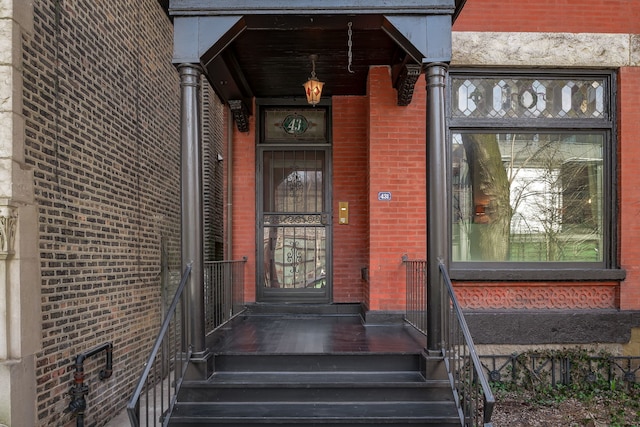 property entrance with brick siding