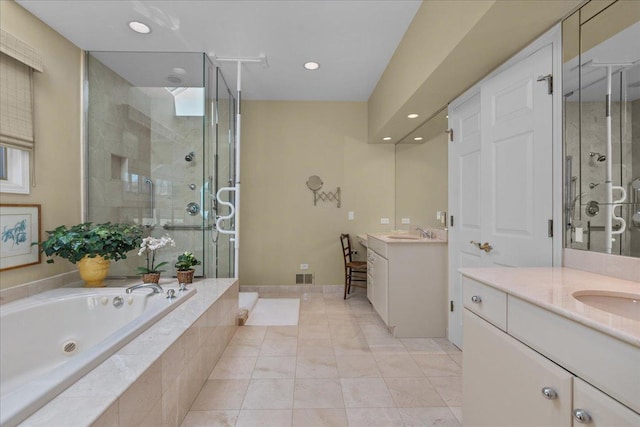 bathroom featuring a bath, two vanities, a sink, a stall shower, and recessed lighting