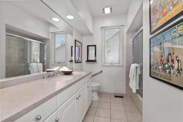full bathroom with vanity, a shower with door, toilet, tile patterned flooring, and visible vents