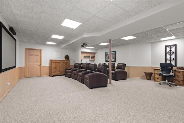 carpeted living room featuring wainscoting and a paneled ceiling