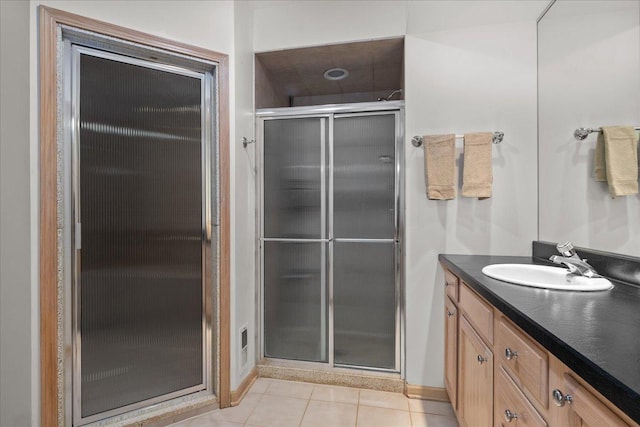 bathroom featuring vanity, tile patterned flooring, and a shower stall