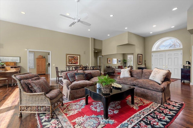 living room with wood finished floors, a ceiling fan, a towering ceiling, and recessed lighting