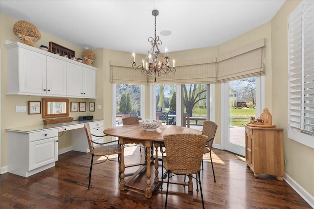dining area featuring a wealth of natural light, a chandelier, and dark wood-style flooring