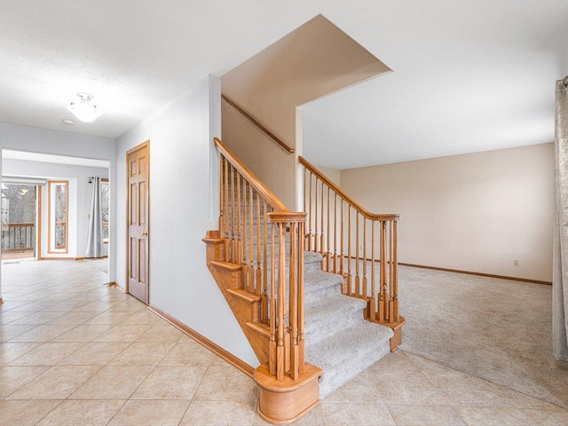 2072 Charnwood Ct, Machesney Park, IL 61115 - staircase with tile patterned floors, carpet flooring, and baseboards