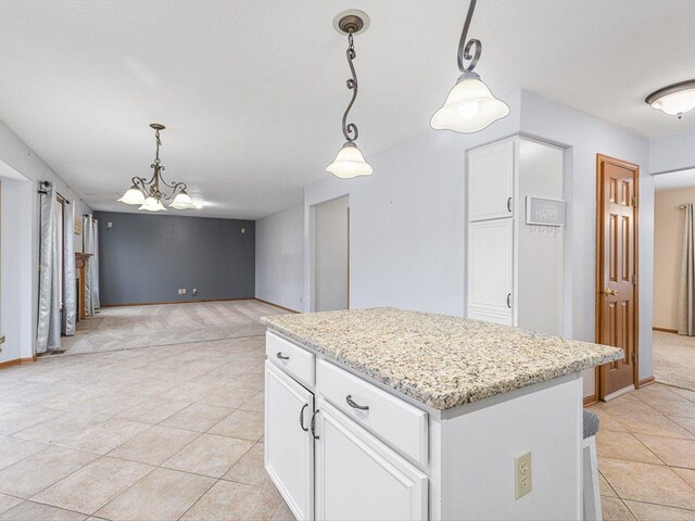 2072 Charnwood Ct, Machesney Park, IL 61115 - kitchen featuring light tile patterned floors, pendant lighting, white cabinetry, and a chandelier