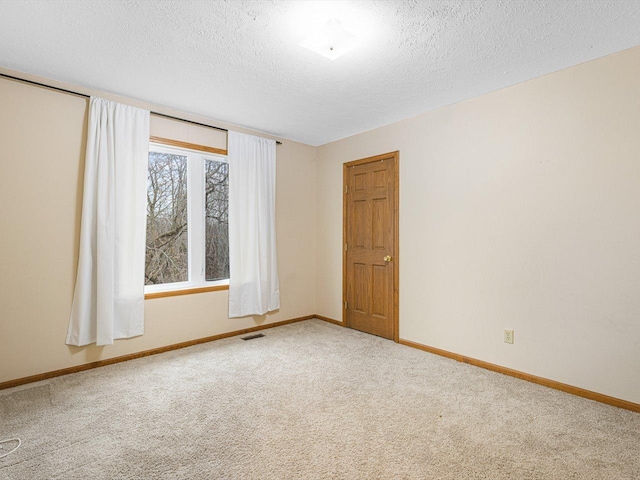 2072 Charnwood Ct, Machesney Park, IL 61115 - carpeted spare room with a textured ceiling, baseboards, and visible vents