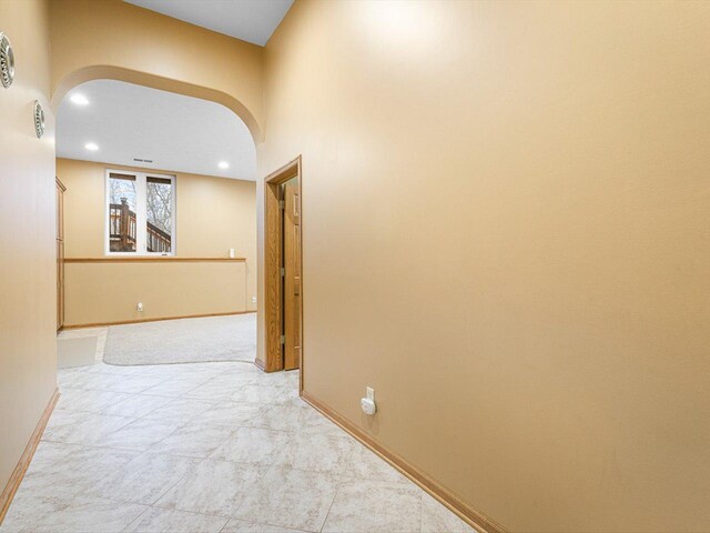 2072 Charnwood Ct, Machesney Park, IL 61115 - hall featuring recessed lighting, arched walkways, baseboards, and light colored carpet