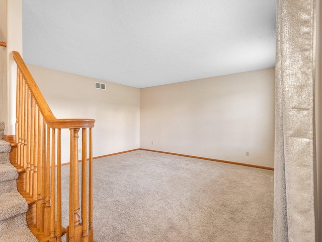 2072 Charnwood Ct, Machesney Park, IL 61115 - unfurnished room featuring visible vents, baseboards, carpet, and stairs