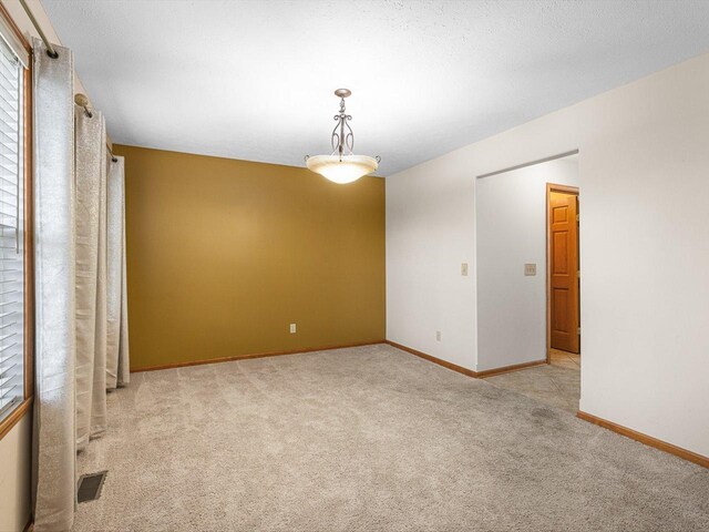 2072 Charnwood Ct, Machesney Park, IL 61115 - unfurnished room featuring baseboards, visible vents, and carpet floors