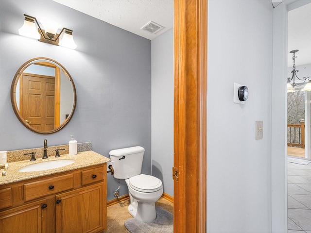 2072 Charnwood Ct, Machesney Park, IL 61115 - half bath featuring toilet, tile patterned floors, vanity, and visible vents
