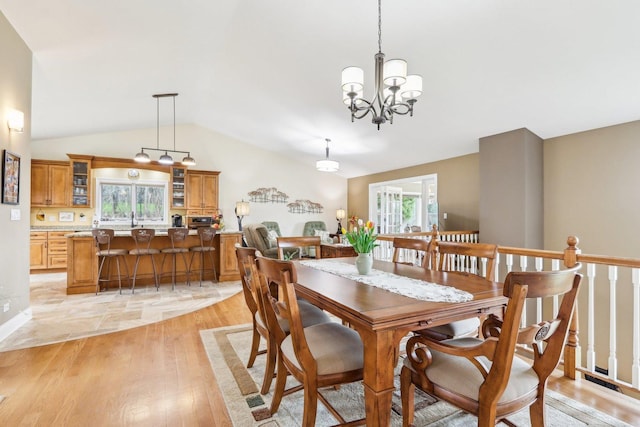 34550 N Stanley Rd, Ingleside, IL 60041 - dining area with light wood-type flooring, a notable chandelier, and lofted ceiling