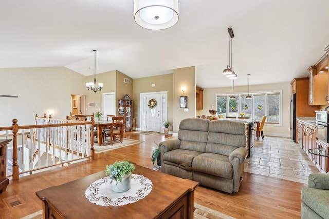 34550 N Stanley Rd, Ingleside, IL 60041 - living room featuring visible vents, baseboards, a notable chandelier, and lofted ceiling