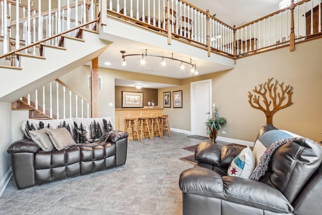 34550 N Stanley Rd, Ingleside, IL 60041 - living room with baseboards, rail lighting, a high ceiling, and stairs