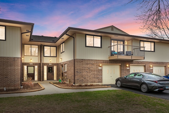 multi unit property featuring a balcony and brick siding