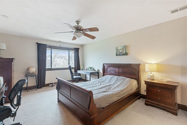 carpeted bedroom featuring baseboards, a ceiling fan, and visible vents