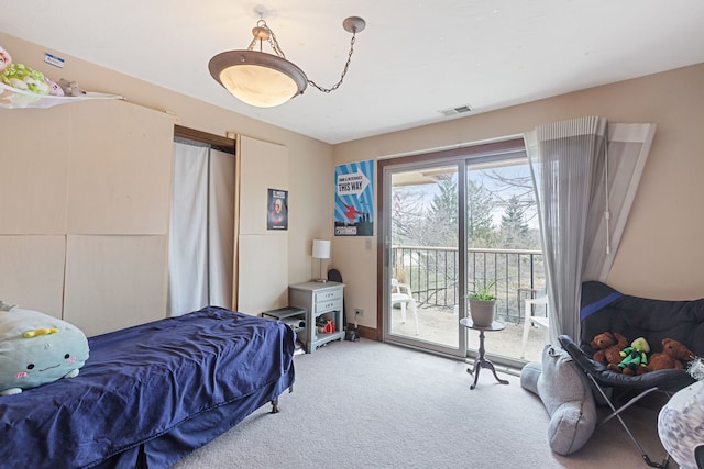 carpeted bedroom featuring visible vents and access to exterior
