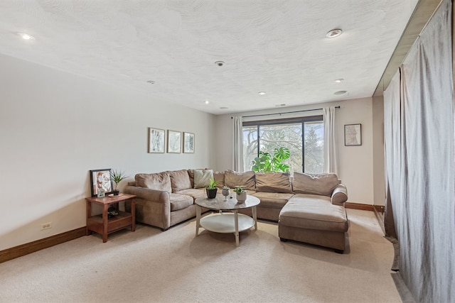 living area featuring light carpet, recessed lighting, and baseboards