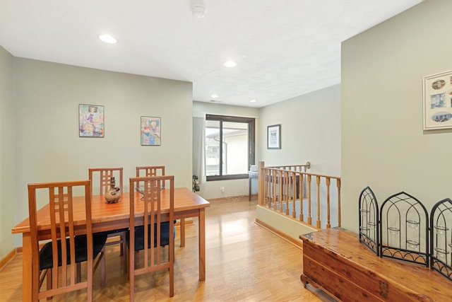 dining space featuring light wood finished floors, baseboards, and recessed lighting