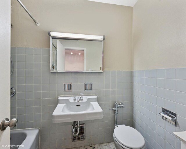 1150 N Lake Shore Dr Unit 20J, Chicago, IL 60611 - bathroom featuring a sink, tile walls, a wainscoted wall, and toilet
