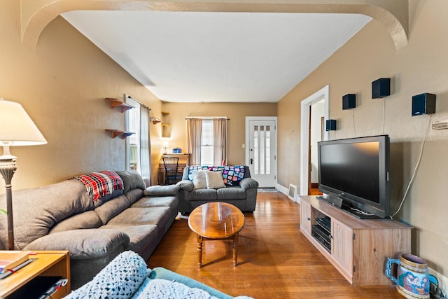 living area with visible vents and wood finished floors