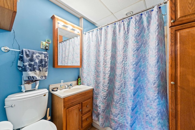 full bathroom featuring vanity, a paneled ceiling, a shower with curtain, and toilet