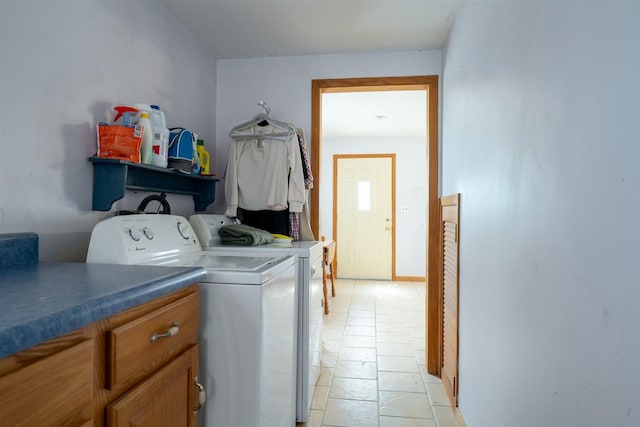 clothes washing area featuring cabinet space and washing machine and clothes dryer