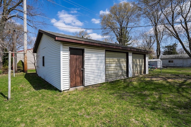 detached garage featuring fence