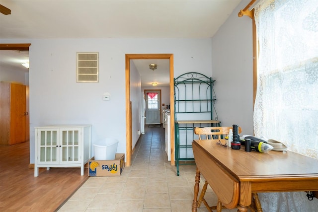 corridor featuring light tile patterned floors