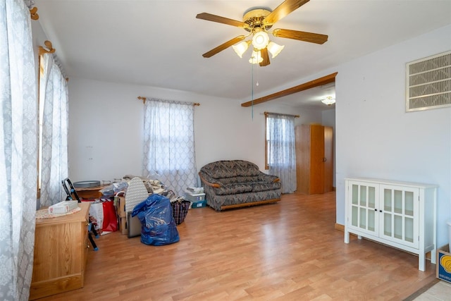 living area featuring wood finished floors, ceiling fan, and visible vents