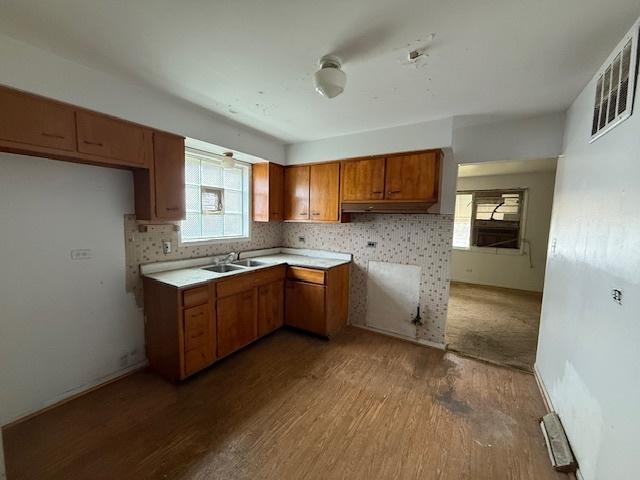 11531 S Throop St, Chicago, IL 60643 - kitchen with brown cabinets, wood finished floors, a sink, and visible vents