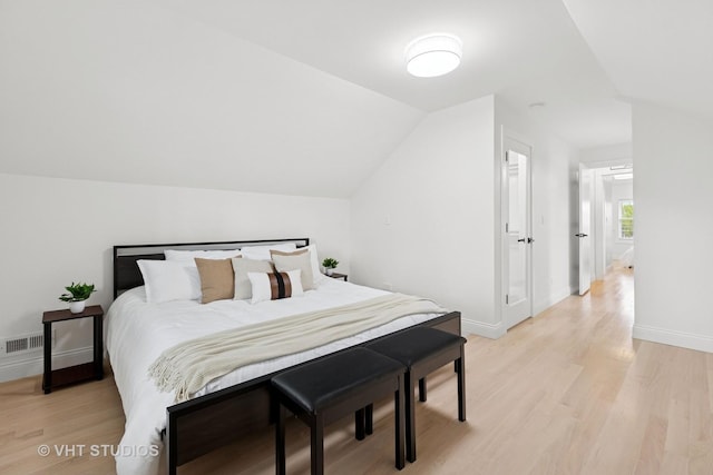 7440 S Oglesby Ave, Chicago, IL 60649 - bedroom featuring light wood-style flooring, baseboards, and vaulted ceiling