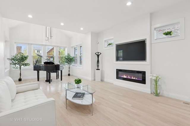 7440 S Oglesby Ave, Chicago, IL 60649 - living room featuring recessed lighting, light wood-style floors, baseboards, and a glass covered fireplace