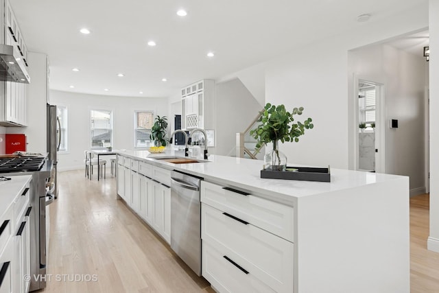 7440 S Oglesby Ave, Chicago, IL 60649 - kitchen with stainless steel appliances, a sink, light wood-type flooring, a spacious island, and recessed lighting