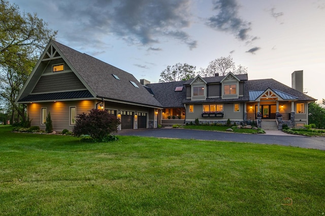 6517 Saddle Ridge Ct, Long Grove, IL 60047 - back of house featuring a chimney, asphalt driveway, a yard, a garage, and roof with shingles
