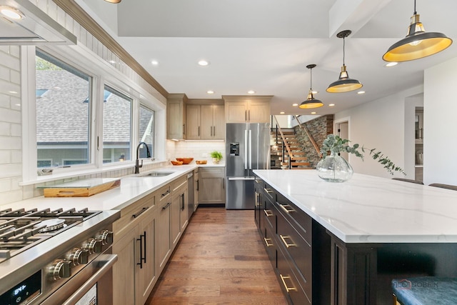 6517 Saddle Ridge Ct, Long Grove, IL 60047 - kitchen with stainless steel appliances, a sink, a center island, tasteful backsplash, and light stone counters