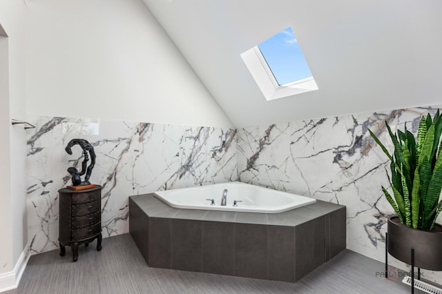 6517 Saddle Ridge Ct, Long Grove, IL 60047 - bathroom featuring a skylight, a bath, tile walls, and vaulted ceiling