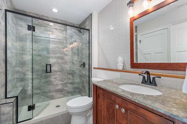 6517 Saddle Ridge Ct, Long Grove, IL 60047 - full bathroom with a stall shower, vanity, toilet, tile walls, and tile patterned floors