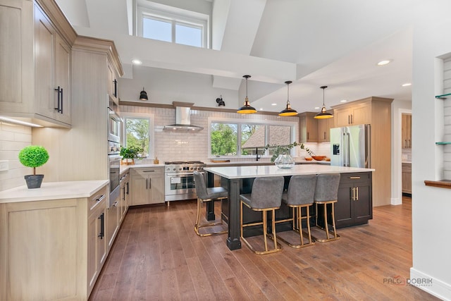 6517 Saddle Ridge Ct, Long Grove, IL 60047 - kitchen featuring high quality appliances, wall chimney range hood, a breakfast bar, a kitchen island, and light countertops