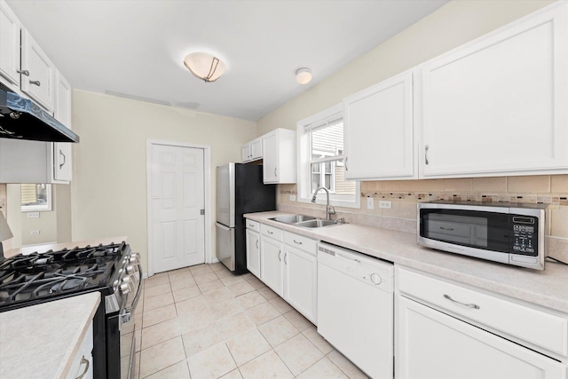 kitchen featuring white cabinets, white dishwasher, gas range, a sink, and freestanding refrigerator