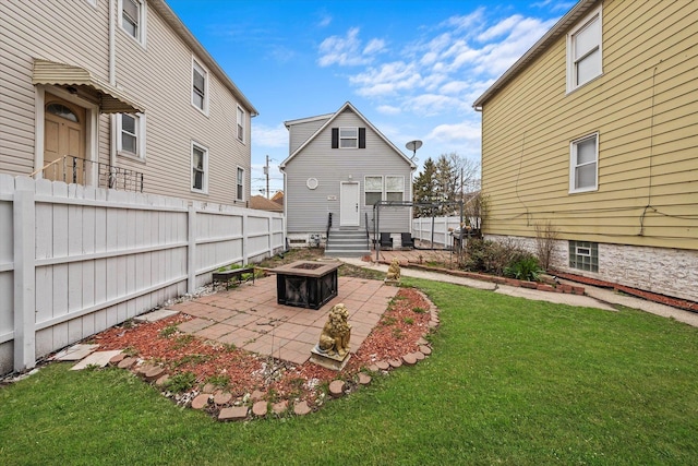 view of yard featuring an outdoor fire pit, fence, and a patio