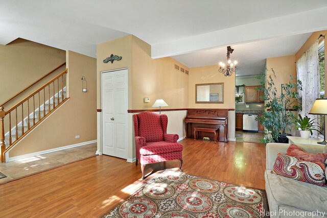437 Deer Run Rd, Lakemoor, IL 60051 - living room with wood finished floors, stairs, a chandelier, beamed ceiling, and baseboards