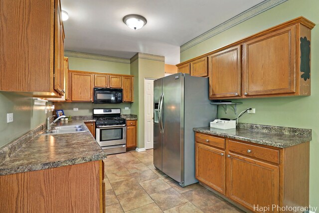 437 Deer Run Rd, Lakemoor, IL 60051 - kitchen with appliances with stainless steel finishes, a sink, brown cabinetry, dark countertops, and crown molding