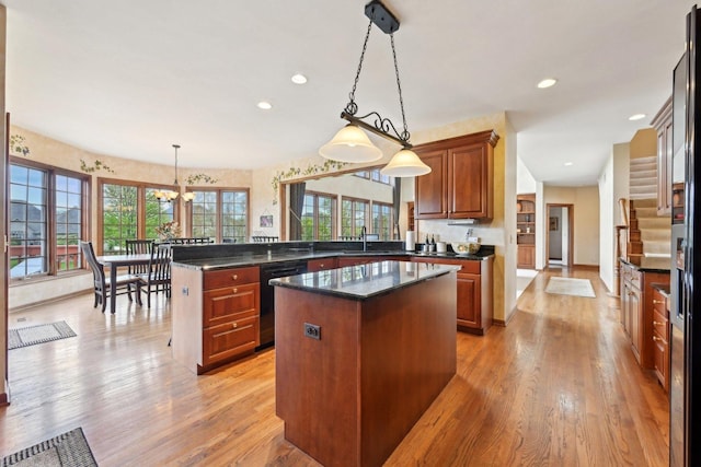 kitchen with dishwasher, a peninsula, a center island, light wood-type flooring, and recessed lighting